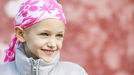Young girl wearing white and pink head bandana