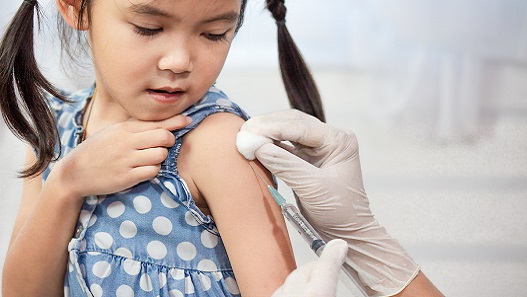 Young girl receiving an immunization at doctor's office