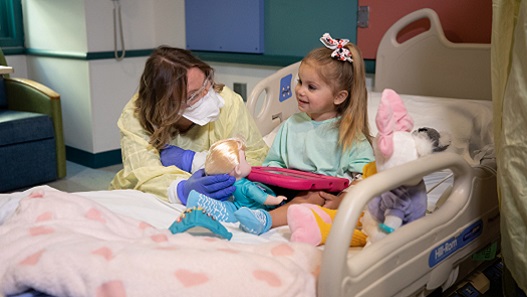 Valley Children's Child Life professional interacting with young patient