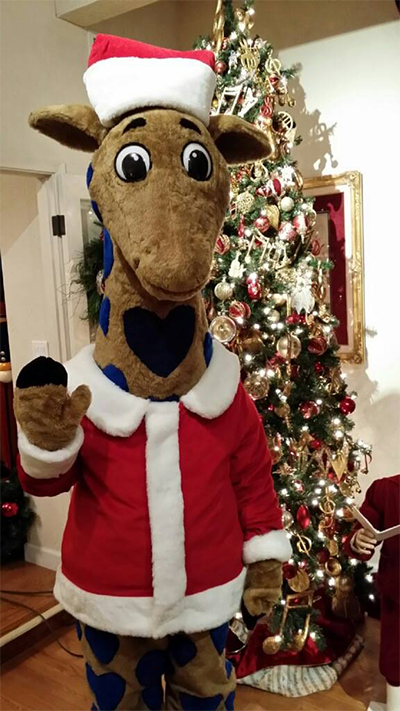 Photo of Valley Children's mascot, George the Giraffe, in a Santa costume