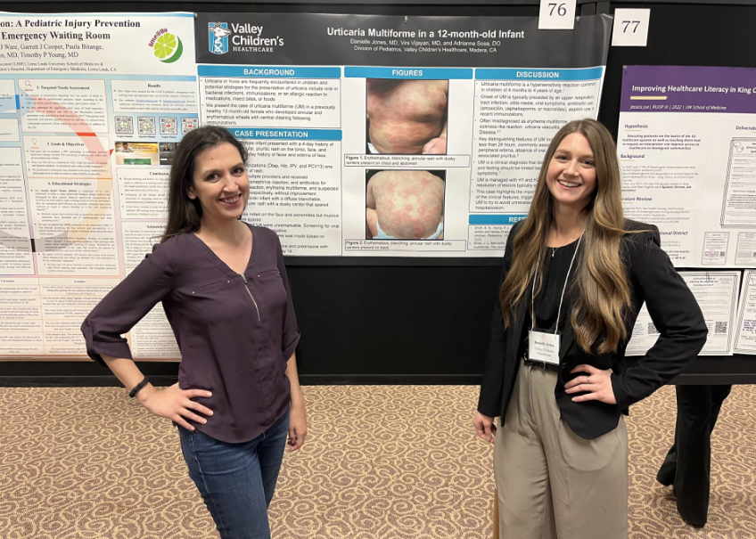 Valley Children's pediatric residents standing in front of their research poster at a research conference