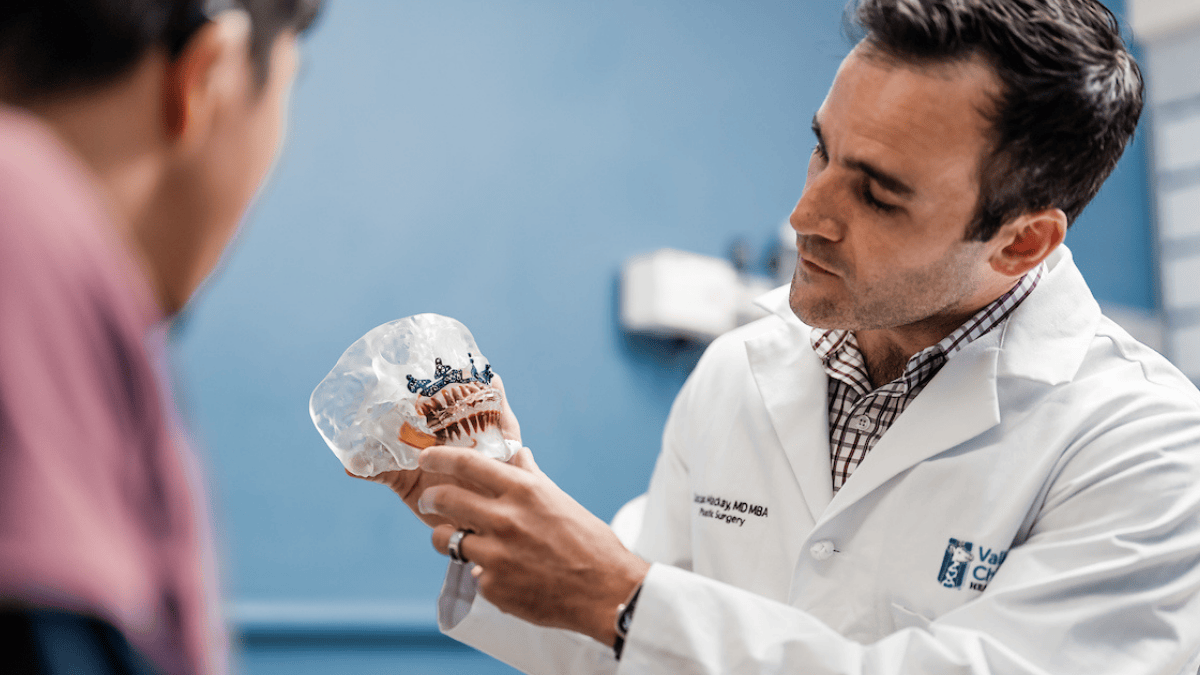 A pediatric plastic surgeon consults with a patient