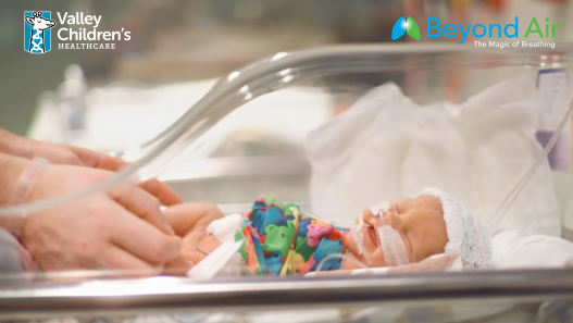 Baby being cared for in an isolette
