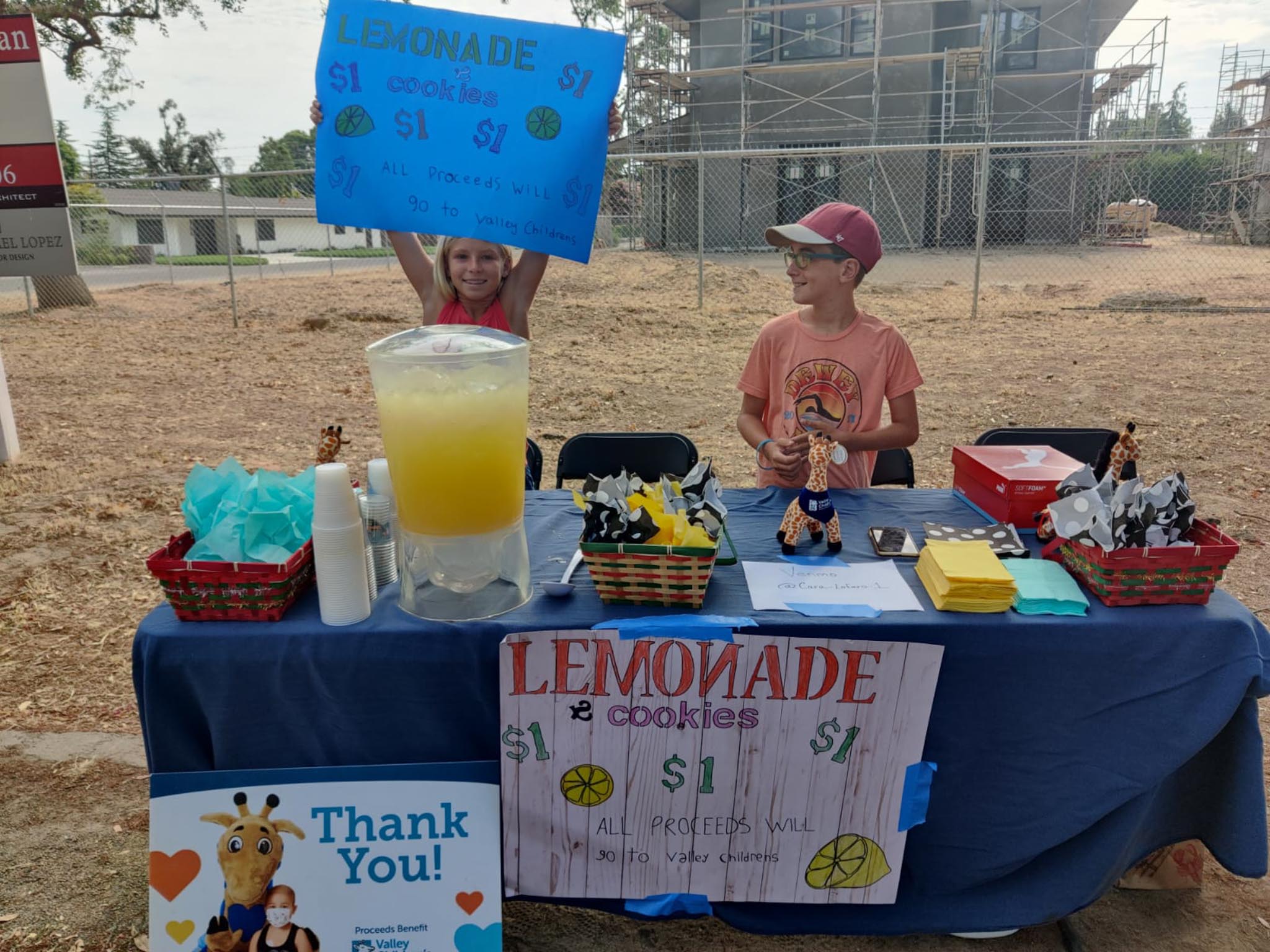 Kids holding lemonade sign