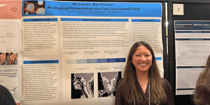 A Valley Children's pediatric resident smiles next to her research poster