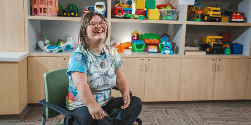 Blair smiles in the Rehab Center playroom