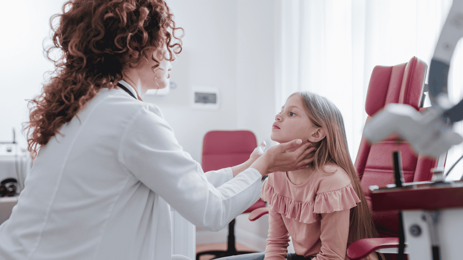 A doctor examines a young patient's throat