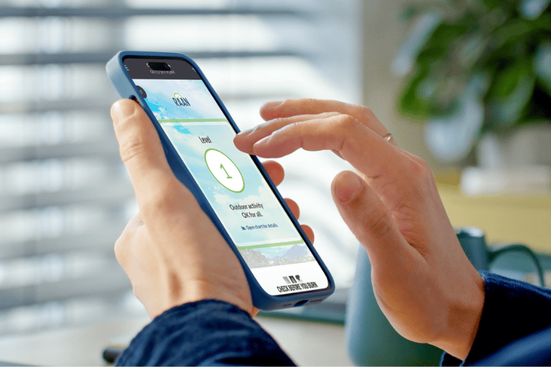 A person holds a smartphone and looks at the Valley Air app