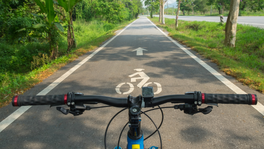 Handle bars of an e-bike on a bike path