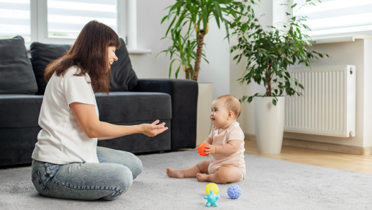 Babysitter playing with child on the floor