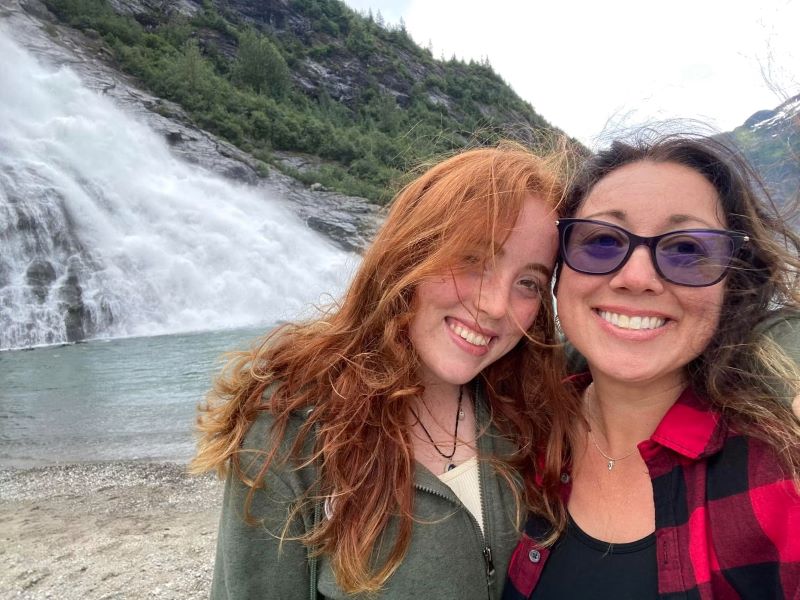 Kara and Christina smile on a hike