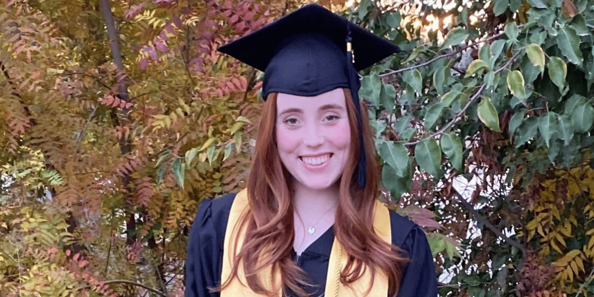Kara smiles in her high school graduation cap and gown