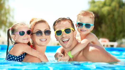 Family having fun in a pool 
