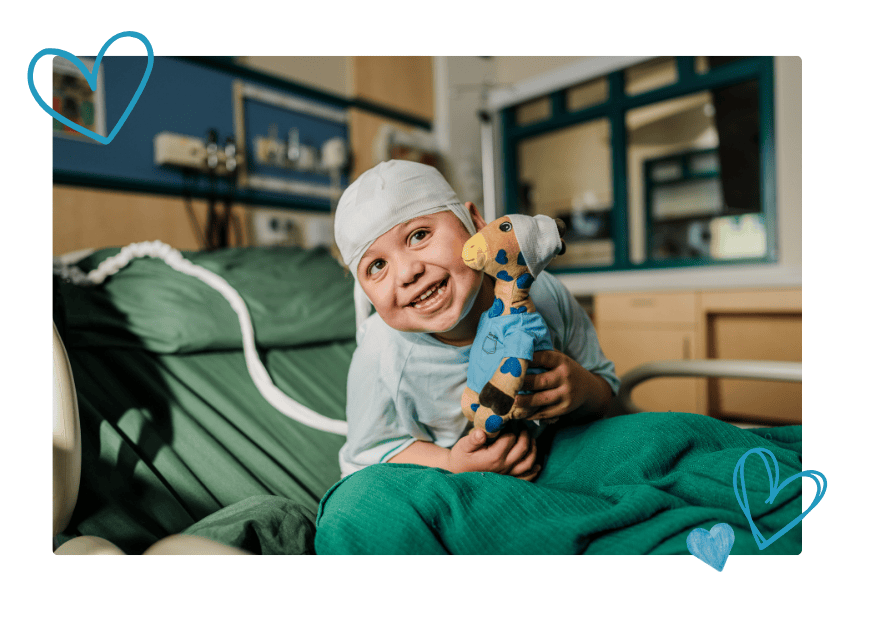 Avie smiles with George the Giraffe in the Epilepsy Monitoring Unit at Valley Children's Hospital