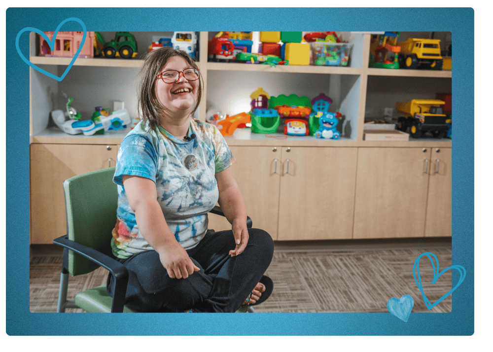 Blair smiles in the Rehab Center playroom