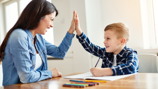 Child high-fiving adult female