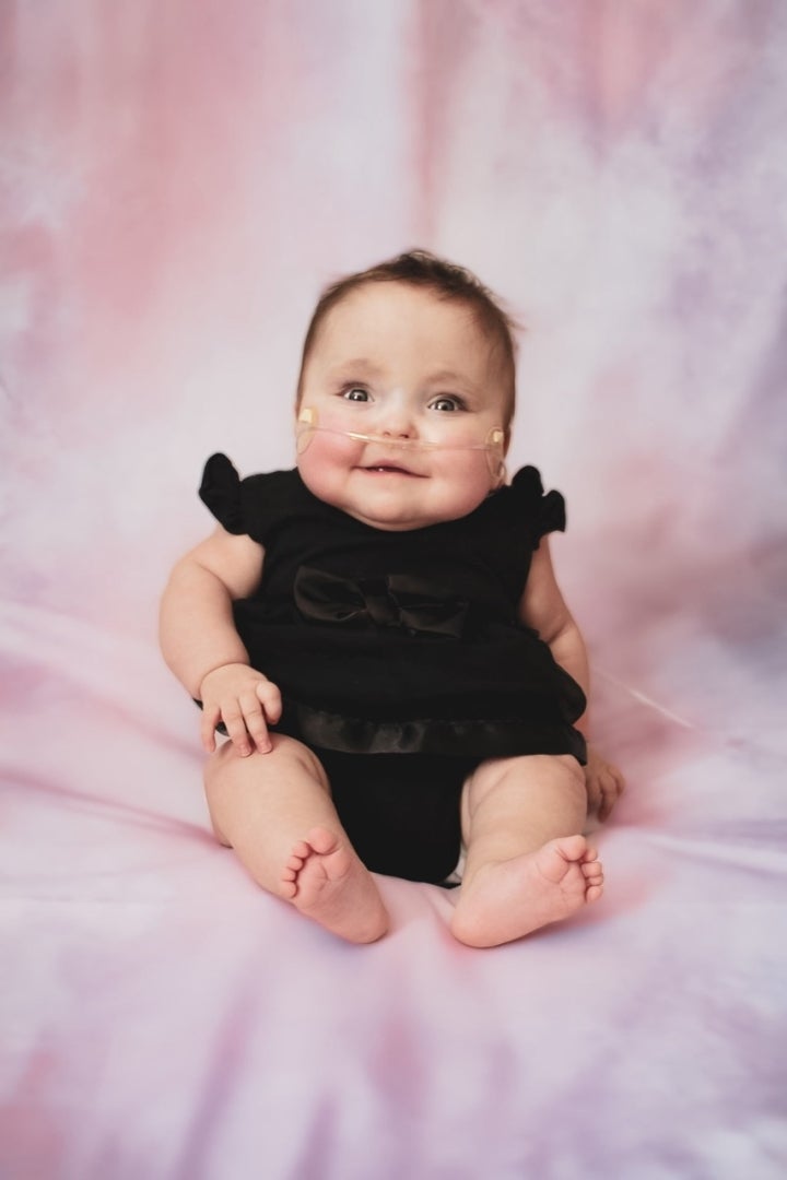 A baby in a black dress
