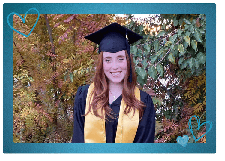 Kara smiles in her graduation cap and gown