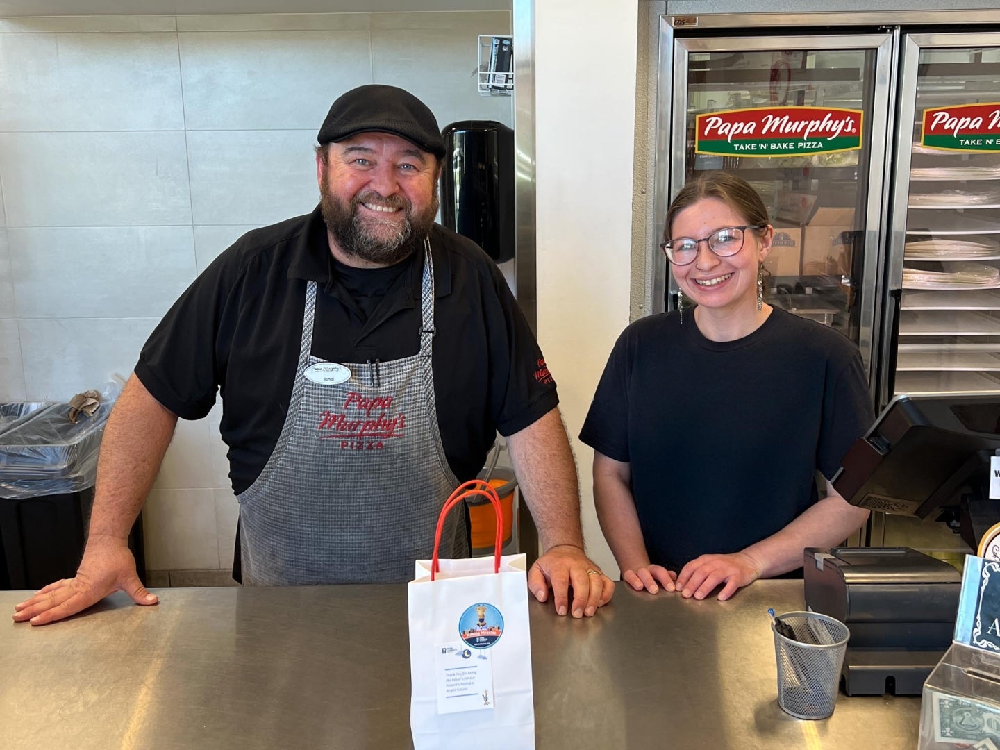 Two people from Papa Murphy's Pizza smiling