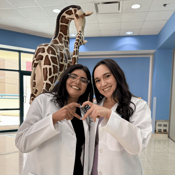 Two pediatric residents smile together