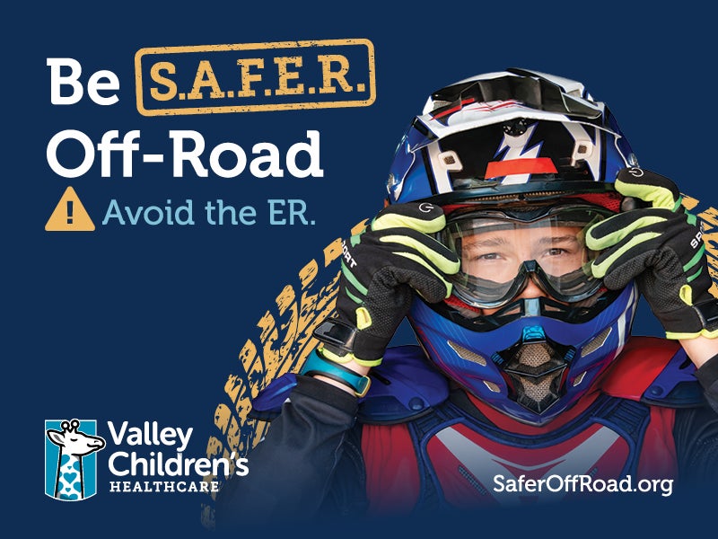 An teenager wears a helmet and protective gear for safer off-road vehicle riding