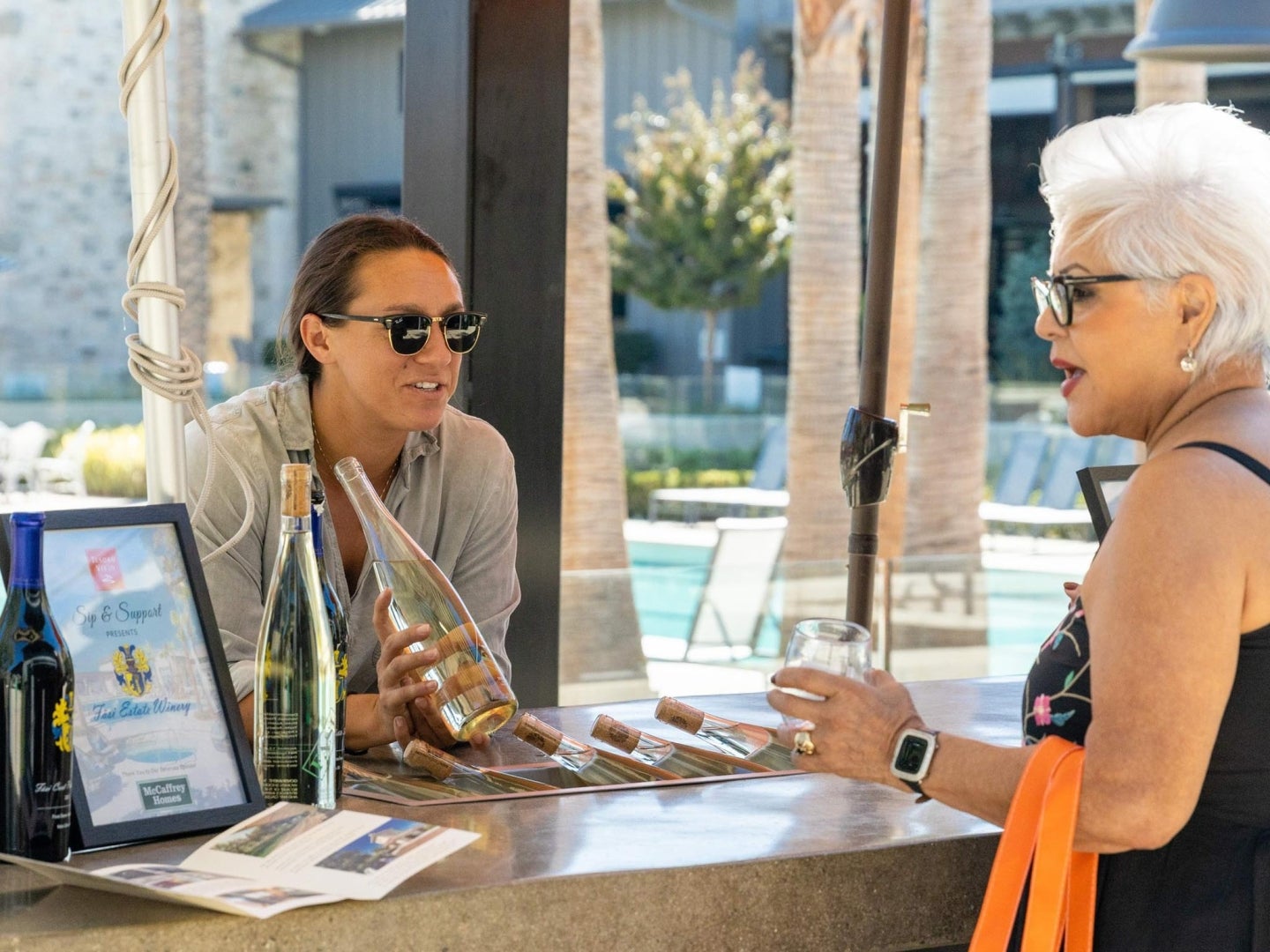 two women talk at wine event